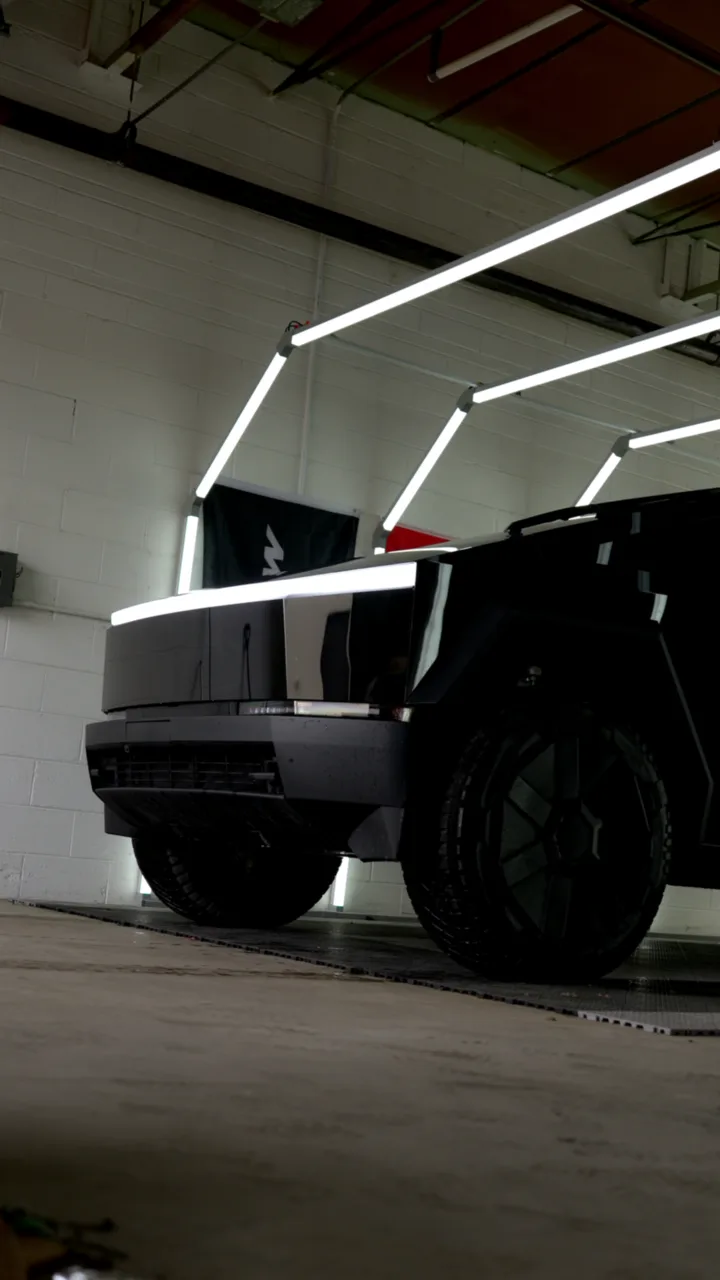 Low angle of a gloss black Cybertruck in the Imperial Auto Films bay in Plymouth, MI